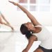 Two healthy women doing yoga in a fresh white room