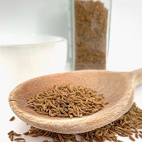 Wooden spoon containing fennel seeds