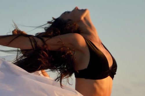 Woman dancing freely in the sunshine, creating a good dose of Vitamin D