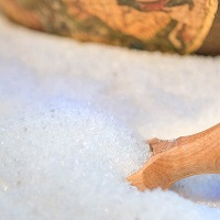 wooden spoon in a tub of salt