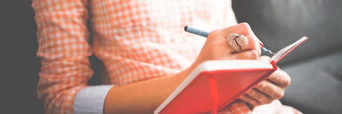 Woman writing in a journal