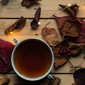 Cup of herbal tea surrounded by festive decorations