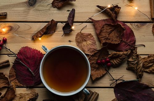 Cup of herbal tea surrounded by festive decorations