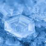 Close up blue image of perfectly formed hexagonal ice crystal